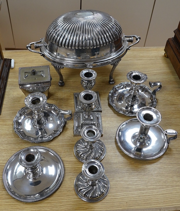 An Edwardian plated breakfast dish and sundry plated wares to include four pairs of candlesticks / chamber sticks. Condition - fair to good